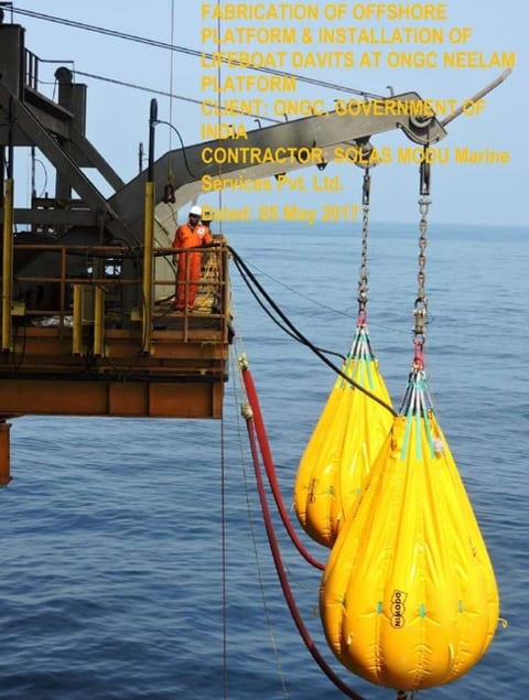 Water filled proof load test bags suspended from a lifeboat davit over open sea during offshore load testing