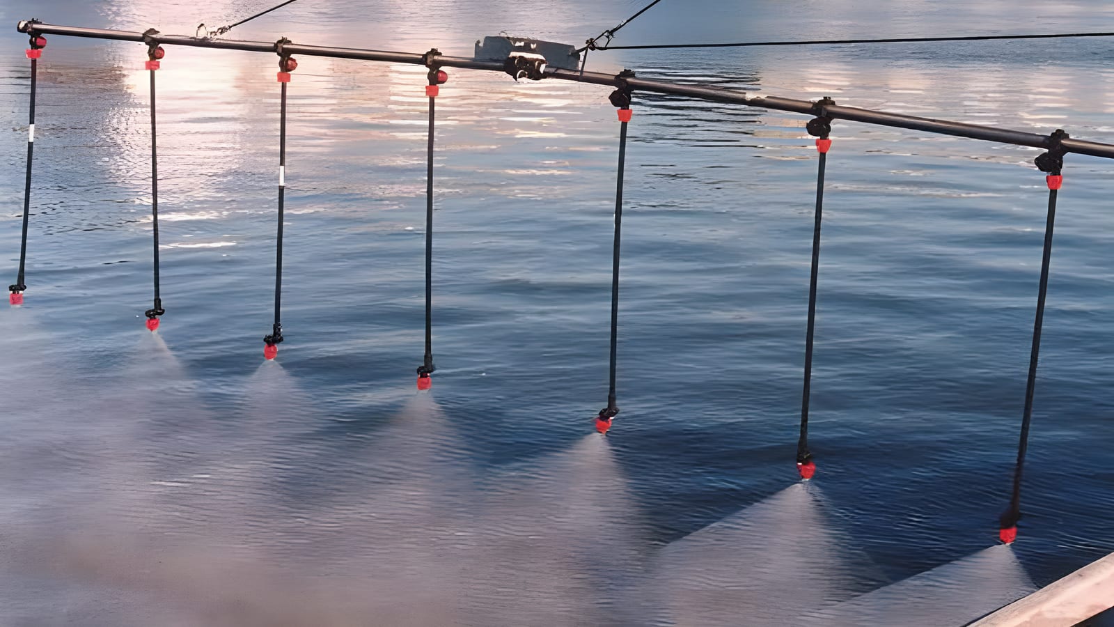 Vessel-mounted spray arm applying dispersant over the water