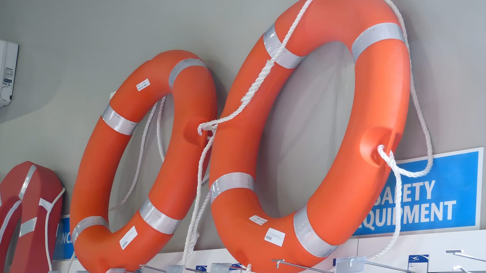 Orange lifebuoy mounted on a vessel railing