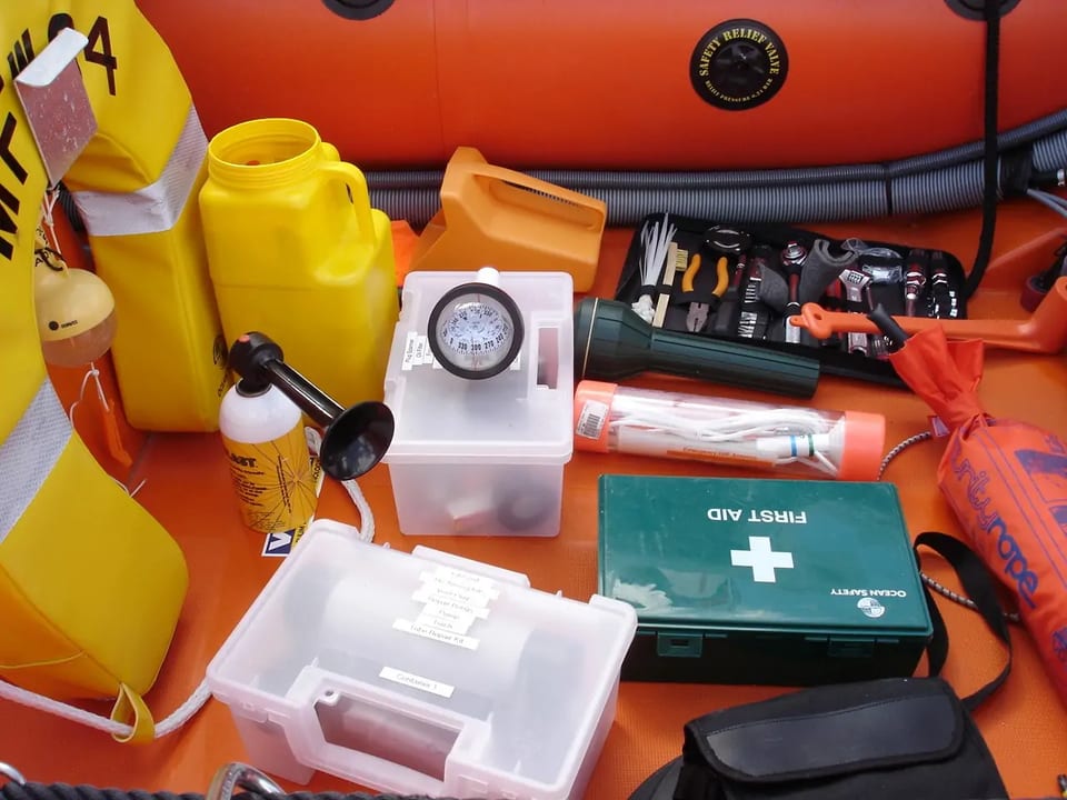 Assorted maritime safety equipment prepared for inspection