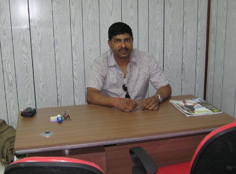 Shore based project office with a marine services manager at a desk during a planning session