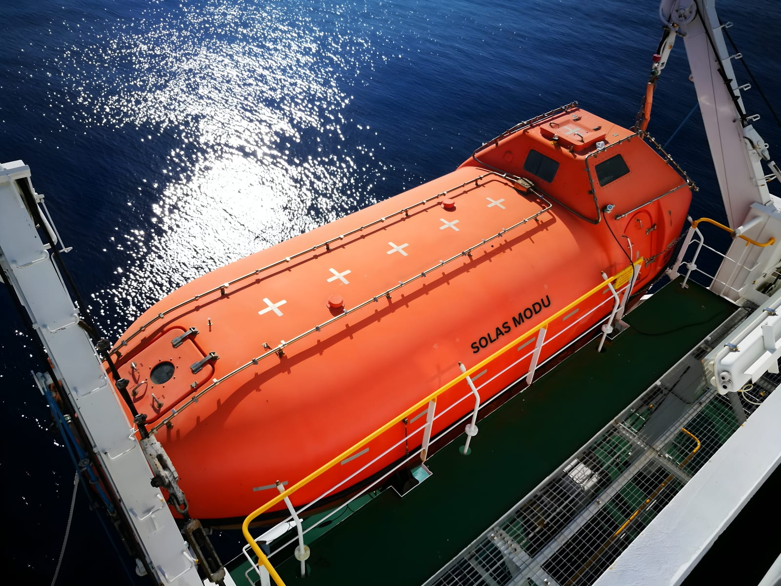 SOLAS MODU technicians deploying a lifeboat during a service operation