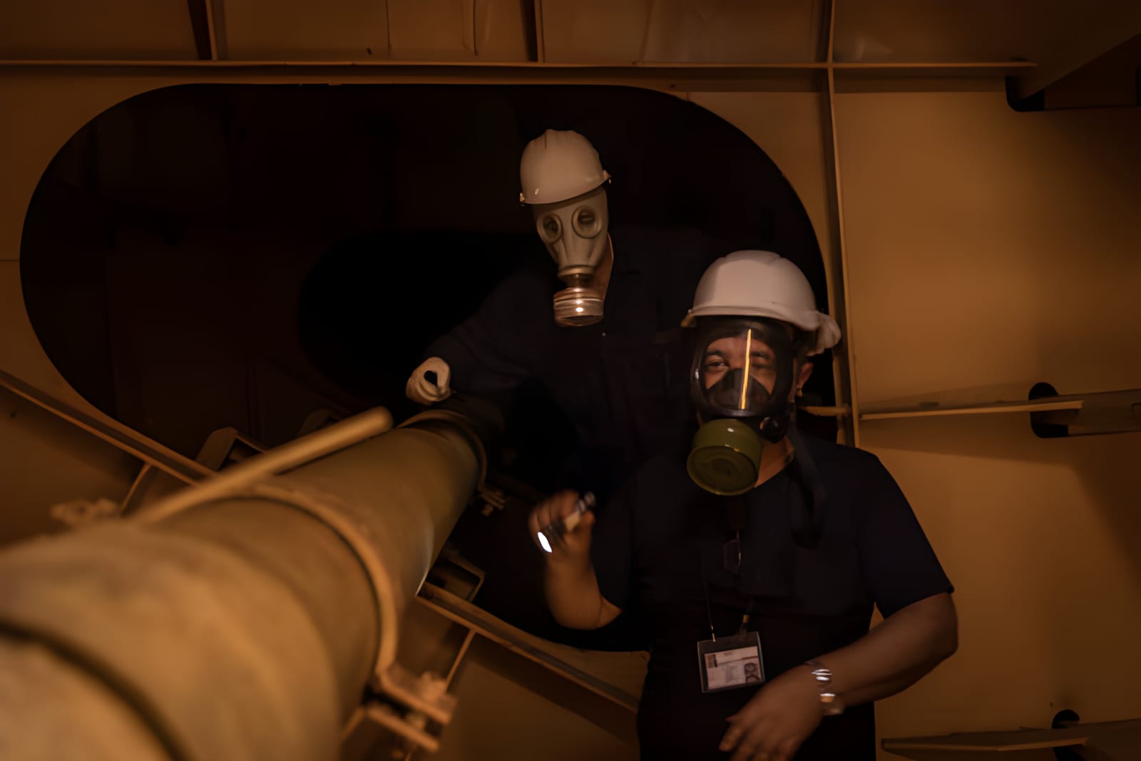 Crew members in protective gas masks during a safety exercise